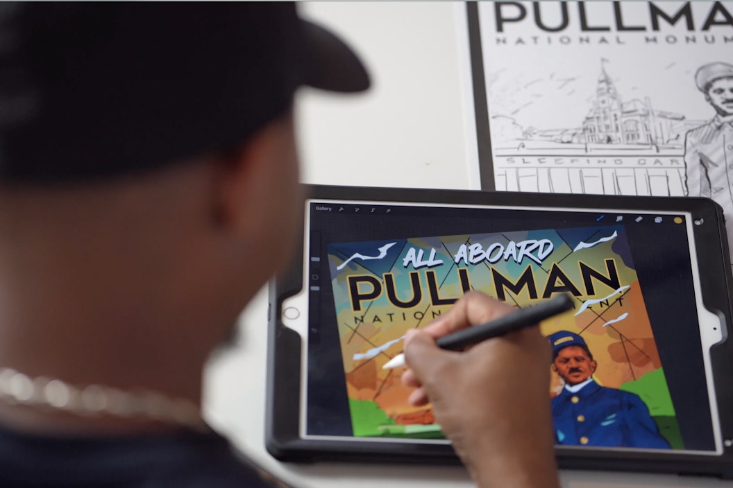 Artist Joe Nelson works on the vintage travel style poster inspired by Pullman National Monument