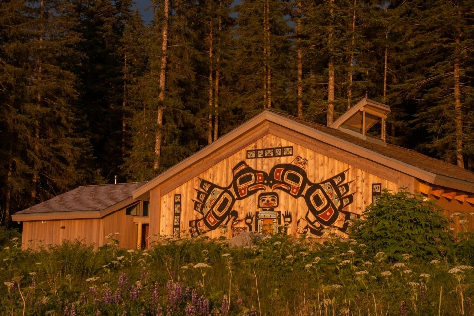 The Huna Tribal house paints a serene scene along the shoreline of Glacier Bay