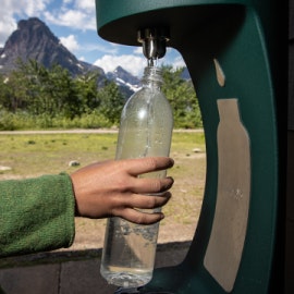 A person uses a waterbottle refill station