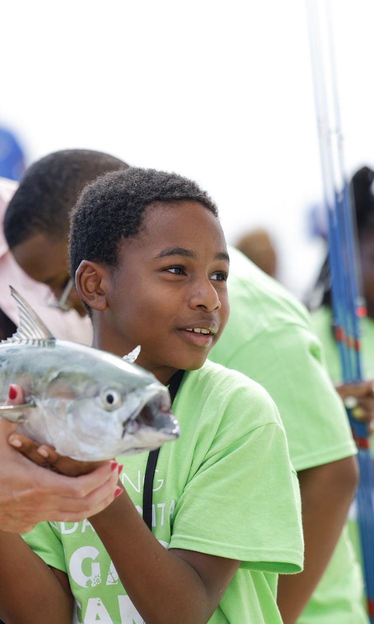 A boy holding a fish