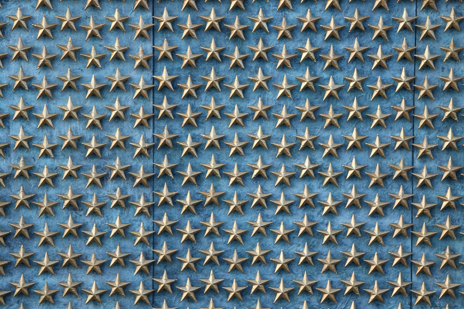 Close up of golden metal stars on a blue stone