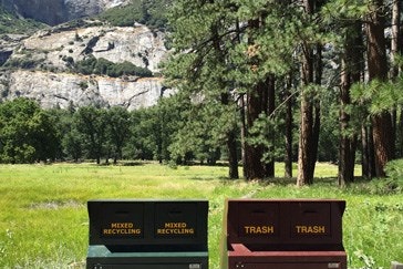 Recycling bins in place at Yosemite. Falls in the background