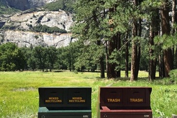 Recycling bins in place at Yosemite. Falls in the background