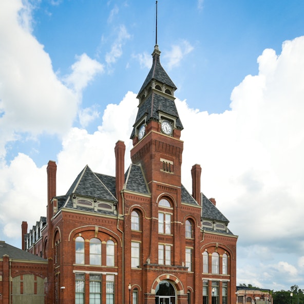 historic facade of a red brick building and clocktower