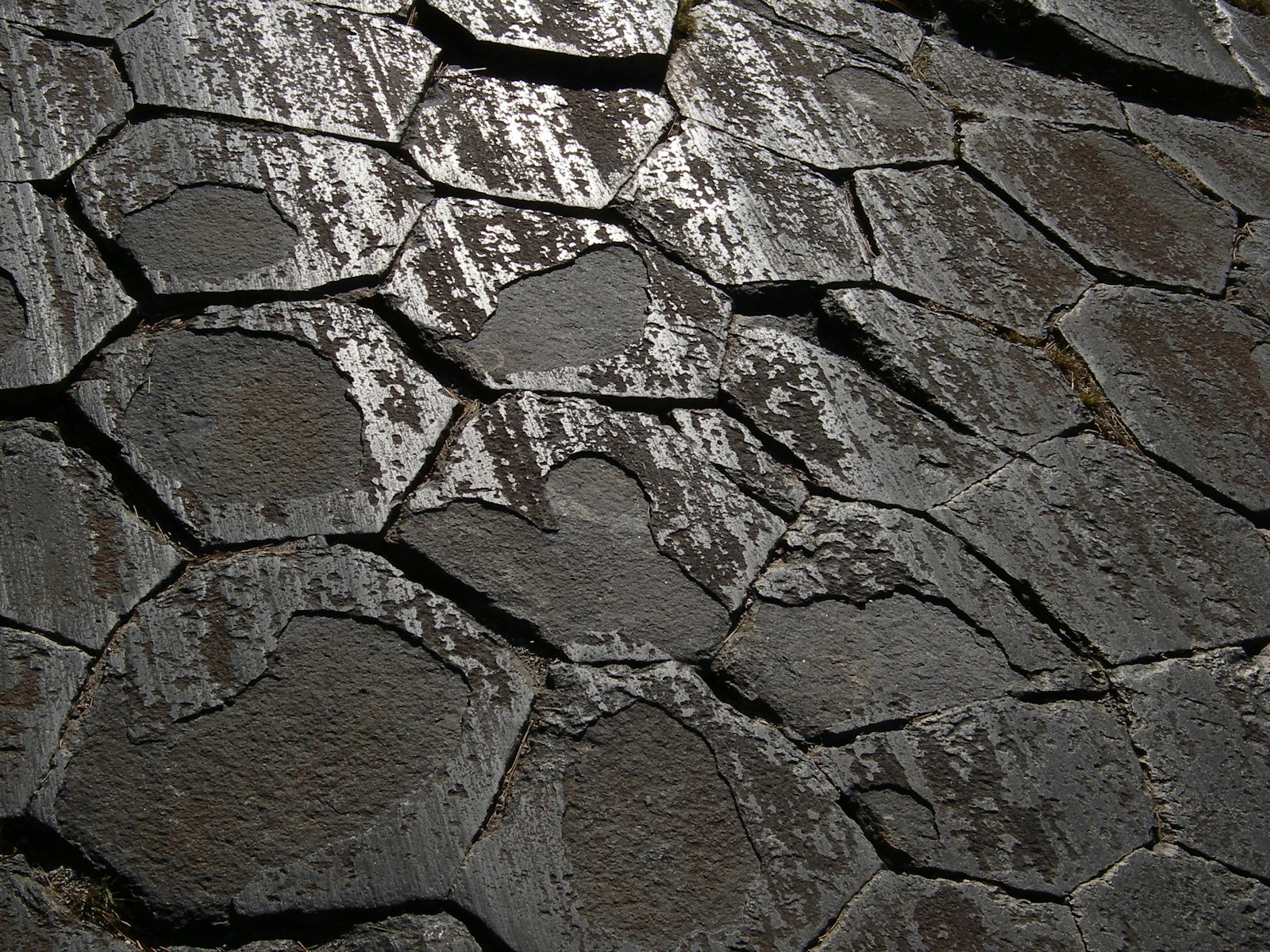Polished facade of irregularly fractured rock