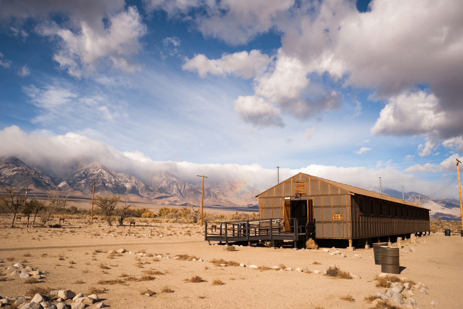 In a desert landscape, a covered building stands
