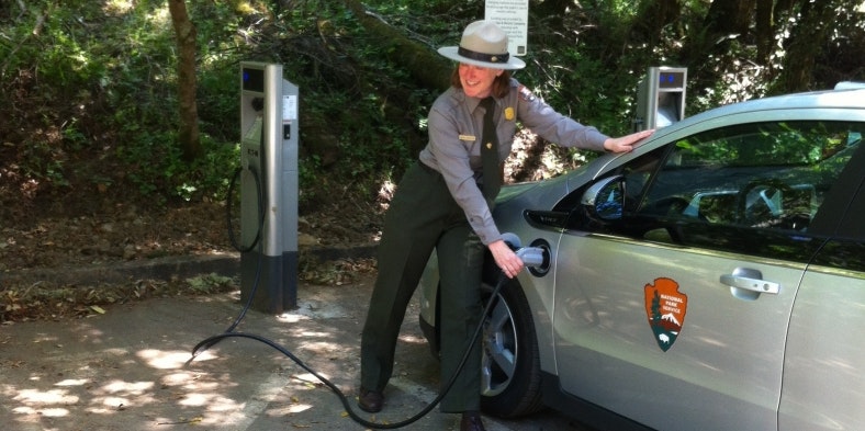A ranger charges an electric car