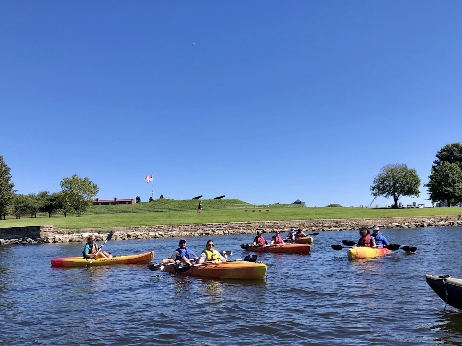 a group of people in kayaks on a lake