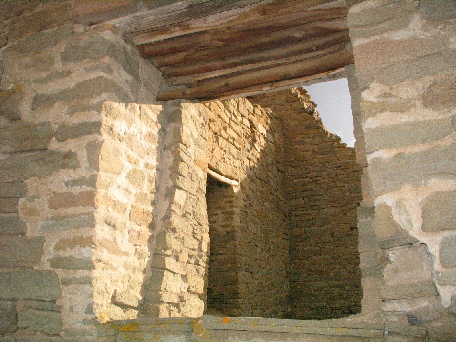 A stone doorway leads into other stone rooms