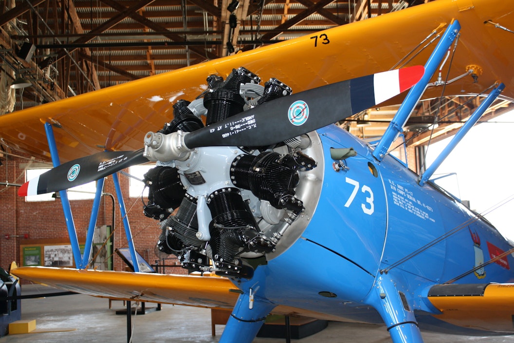 Close up of a blue biplane with yellow wings