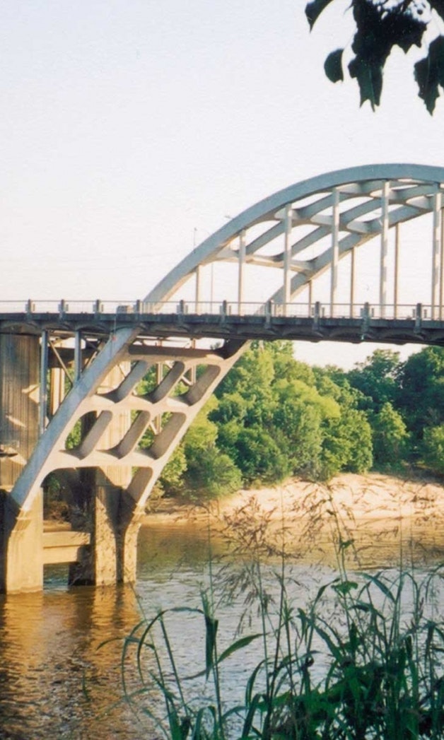 An arched steel bridge over a river