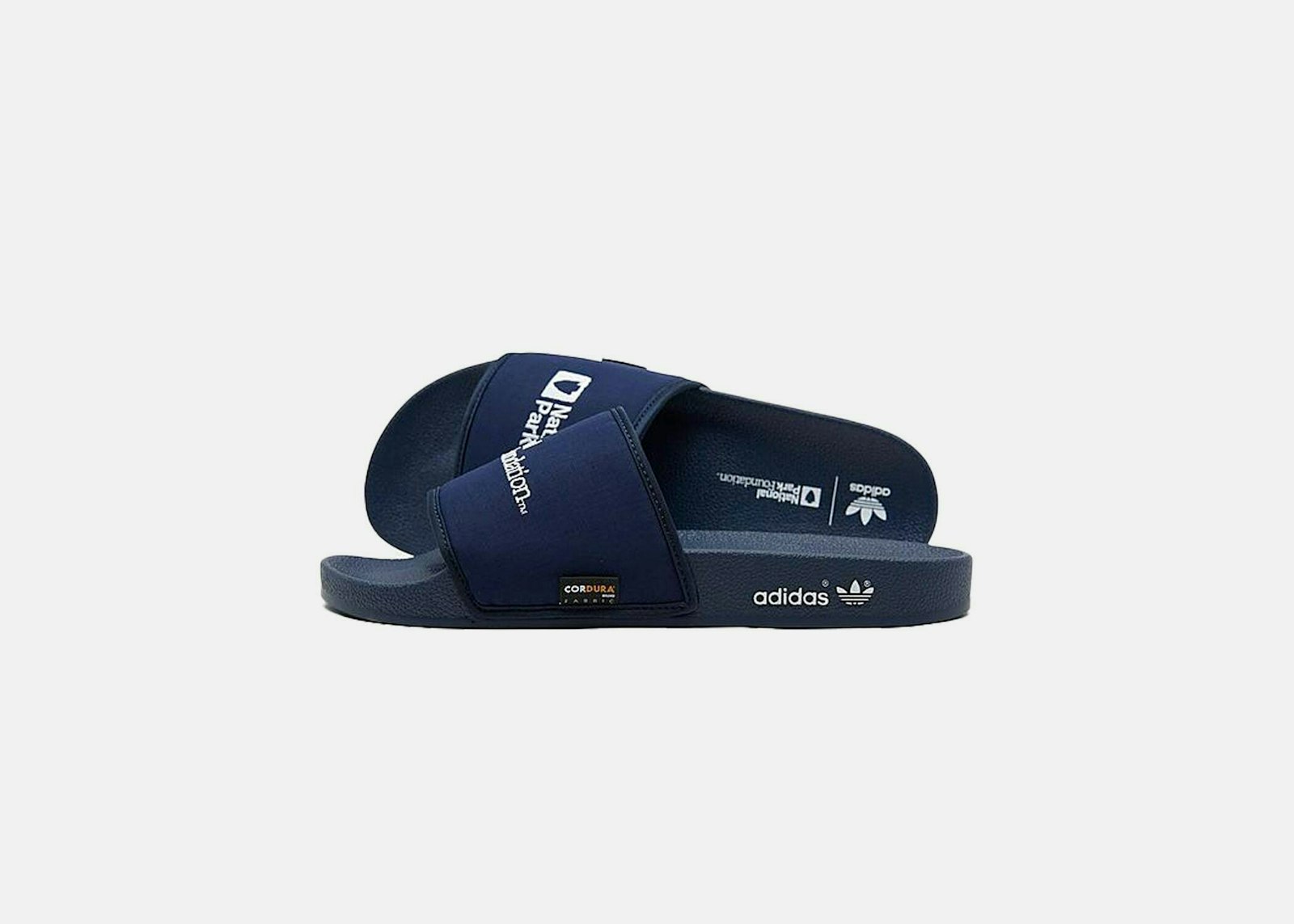 Blue slide sandals with the National Park Foundation logo on them