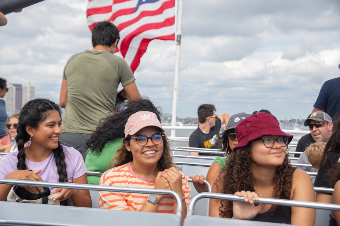 People sit and smile on a ferry boat