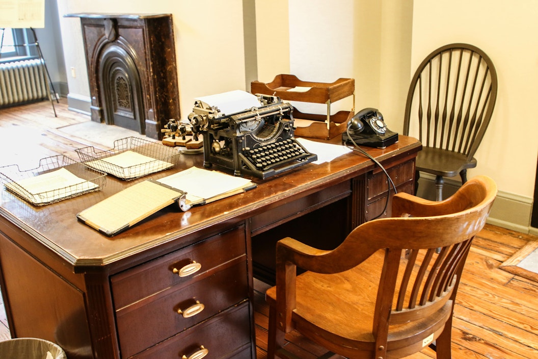 Wooden desk with typewriter and papers