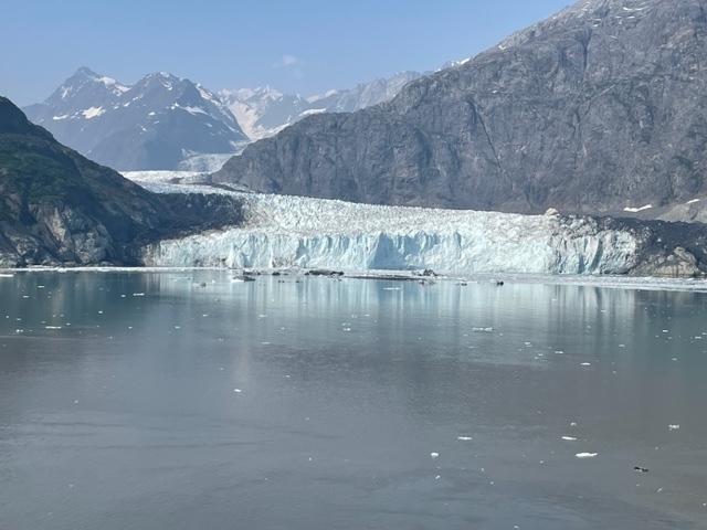 Mountains above a white-blue ice of Glacier.