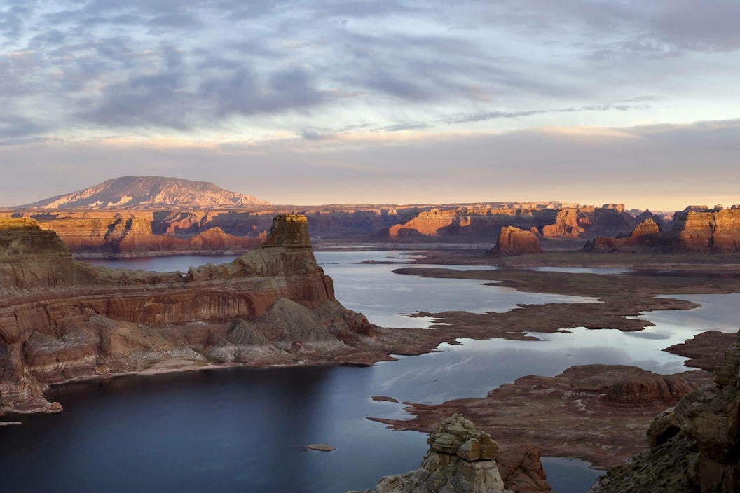 Light illuminates the far distance of canyons cutting across water