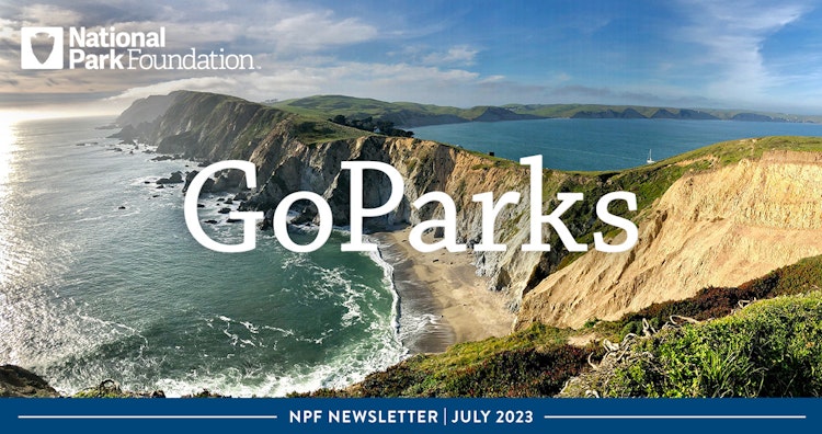 Over an image of a stretch of cliffs reaching out and winding into the ocean, text reads: "National Park Foundation; GoParks; NPF Newsletter: July 2023"