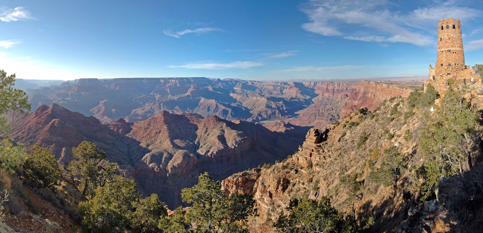 scenic overlook into a large canyon. on the right, a stone watchtower