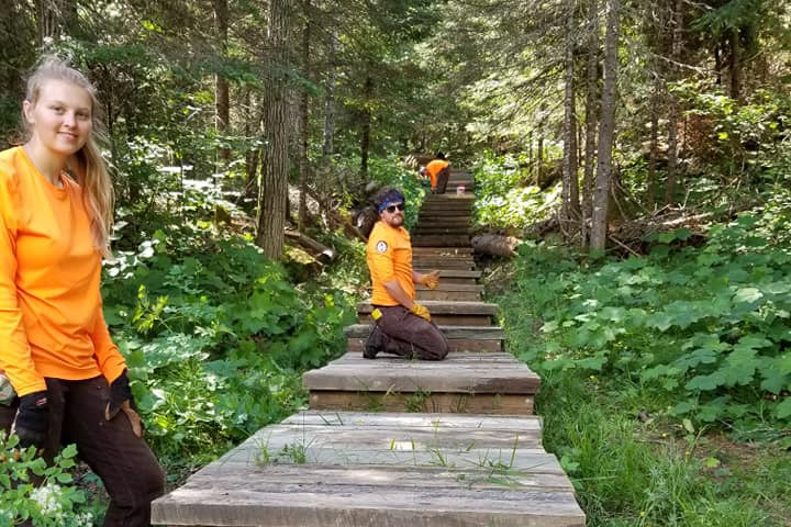 Service corps crew members pose on a newly constructed wooden trail