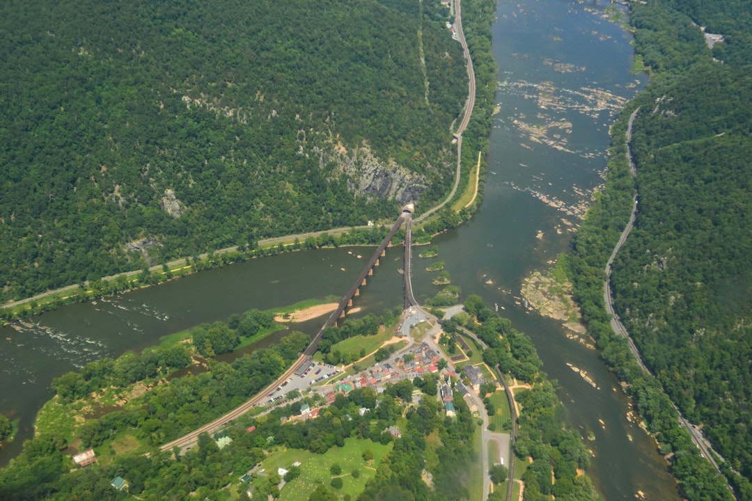 Aerial photograph depicting a confluence of rivers and a small town nestled between them