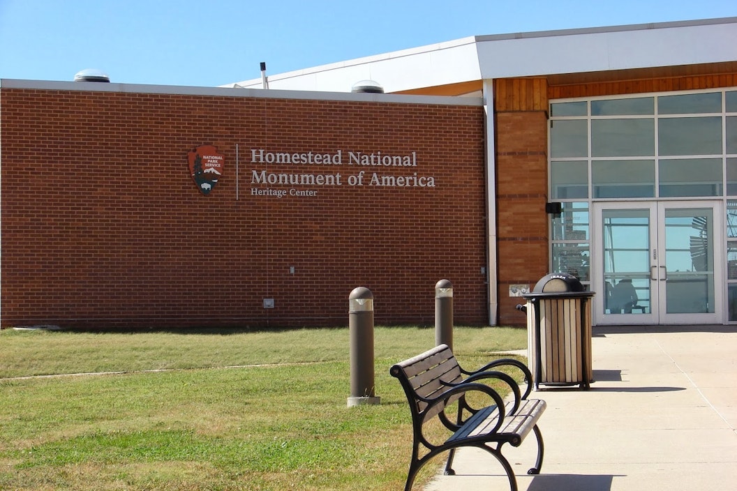 A bench sits outside the entrance to the Homestead Heritage center.