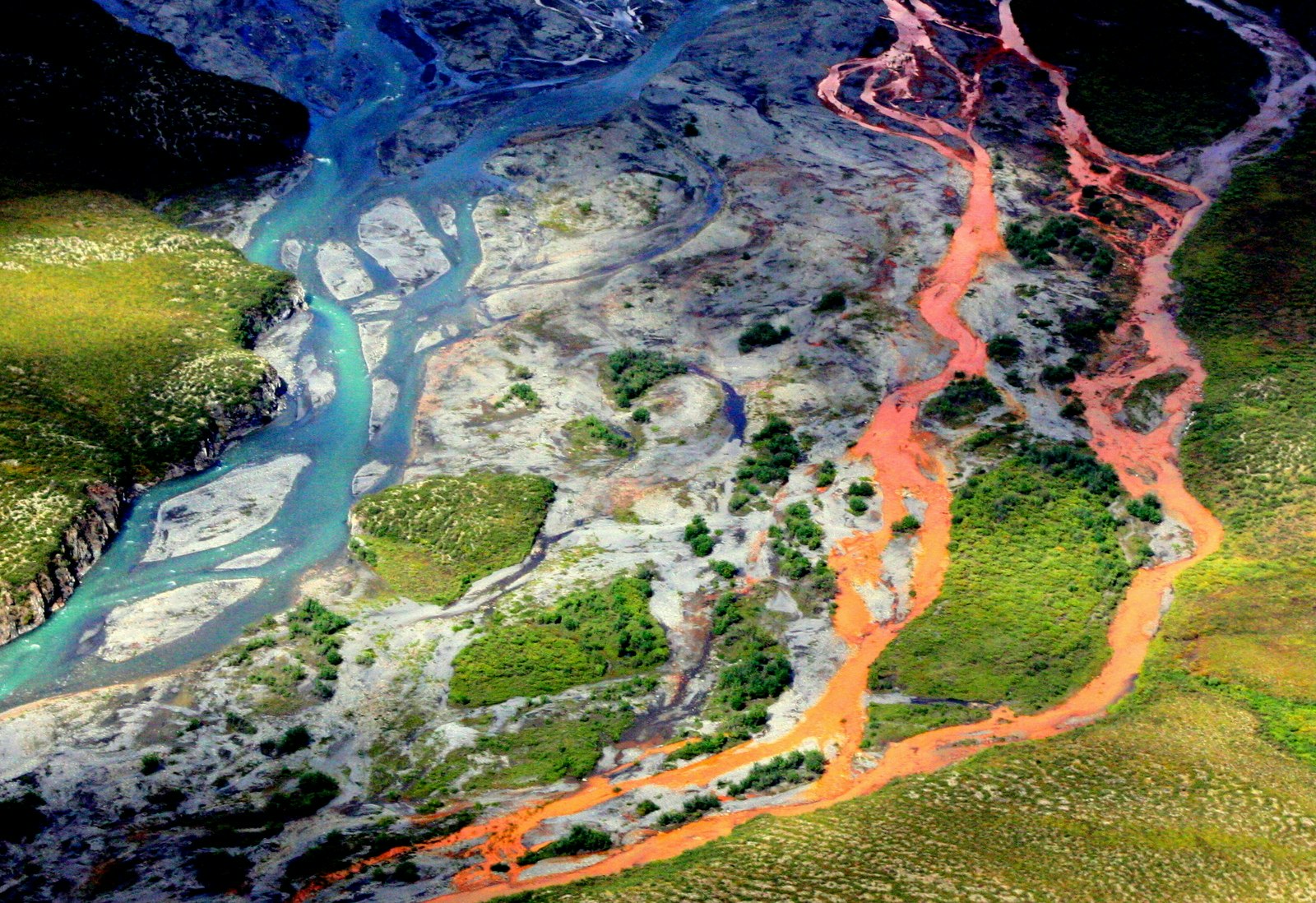 An aerial view of a rust-colored river in Gates of the Artic National Park in Alaska