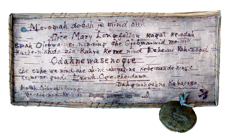 Birchbark with writing in a dark purple ink