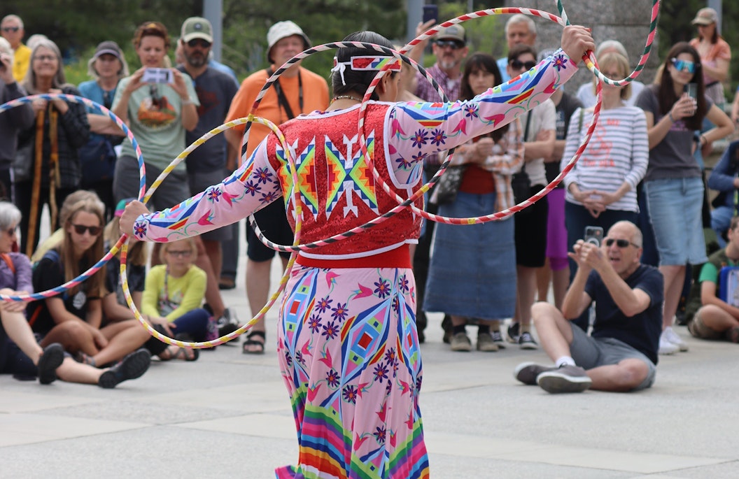 An Indigenous artist performs before a crowd