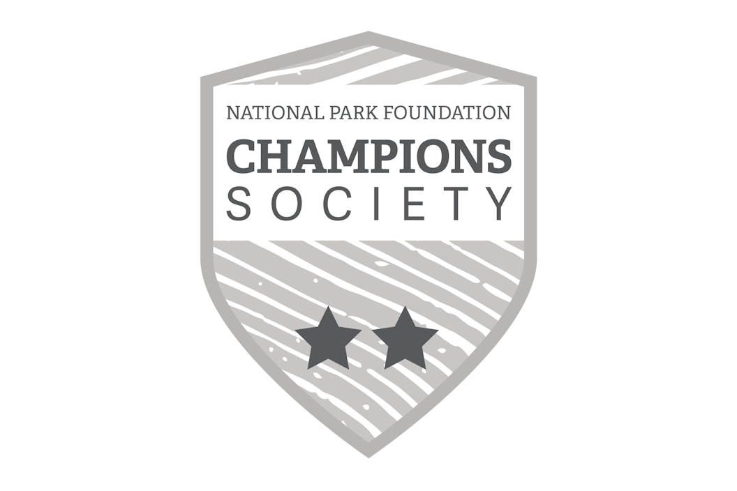 Illustration of a badge that reads "National Park Foundation, Champions Society" with 2 stars
