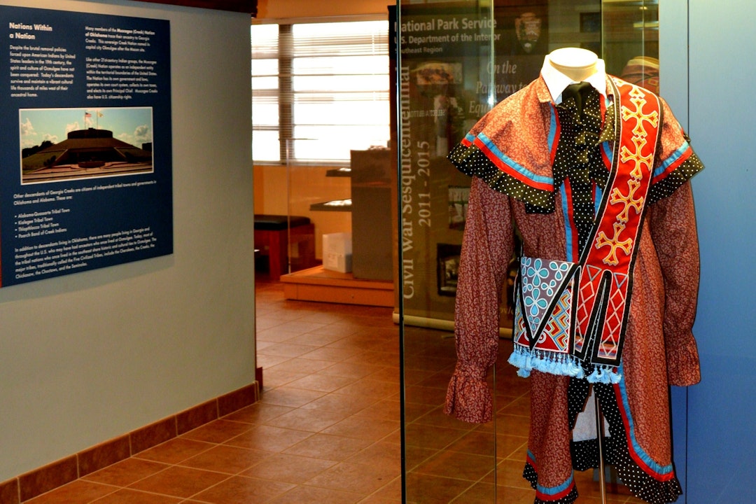 Historic clothes on display behind glass in an exhibit