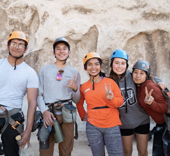 A group of people in climbing gear pose for a photo