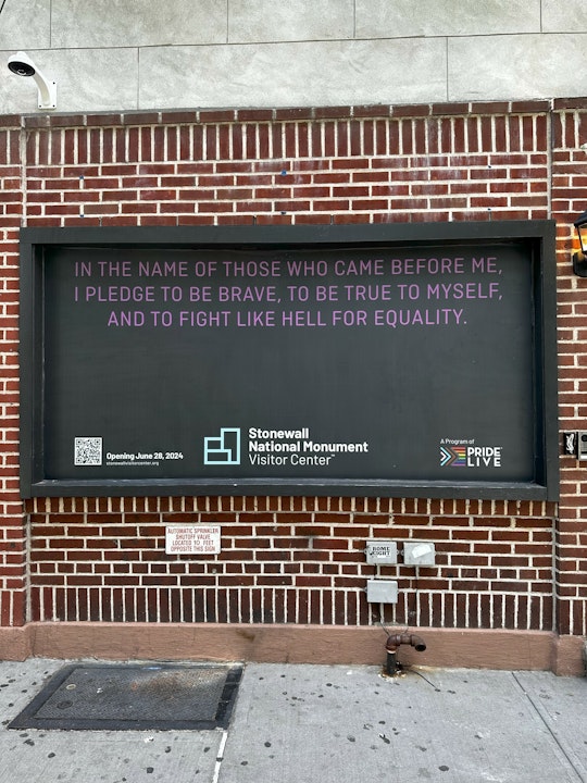 A brick wall with text that reads "In the name of those who came before me, I pledge to be brave, to be true to myself, and to fight like hell for equality.”