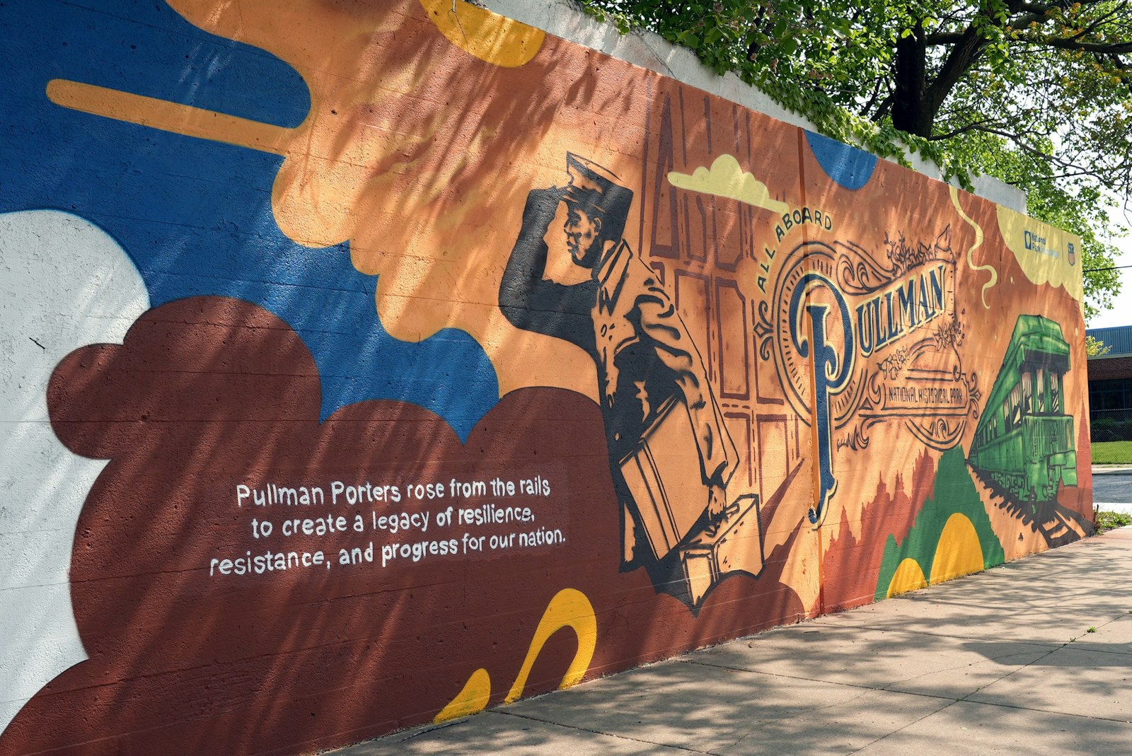 A mural depicting a Pullman porter looking out to the left. Text reads "Pullman Porters rose from the rails to create a legacy of resilience, resistance, and progress for our nation. All abroad Pullman National Historical Park"