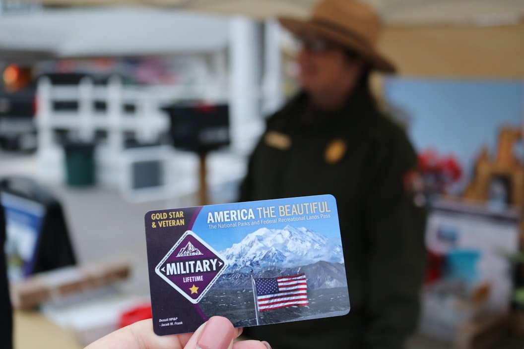 Close up of a Military Lifetime Pass - in the background, a park ranger in uniform