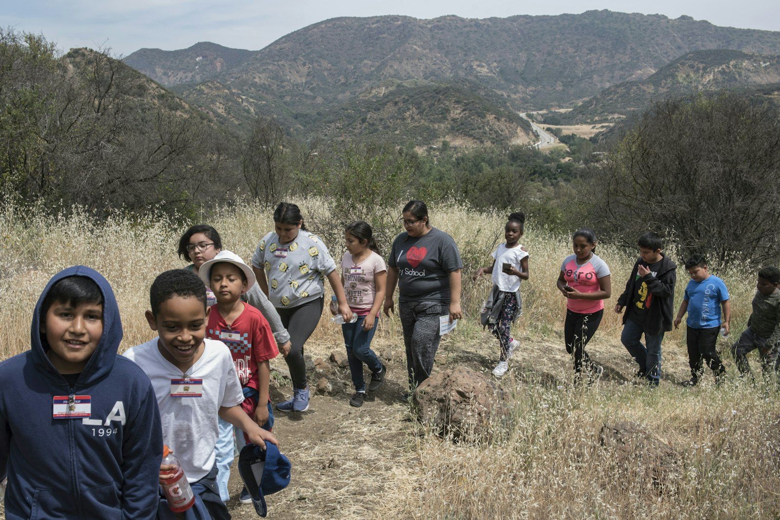 A group of kids walk through the mountains