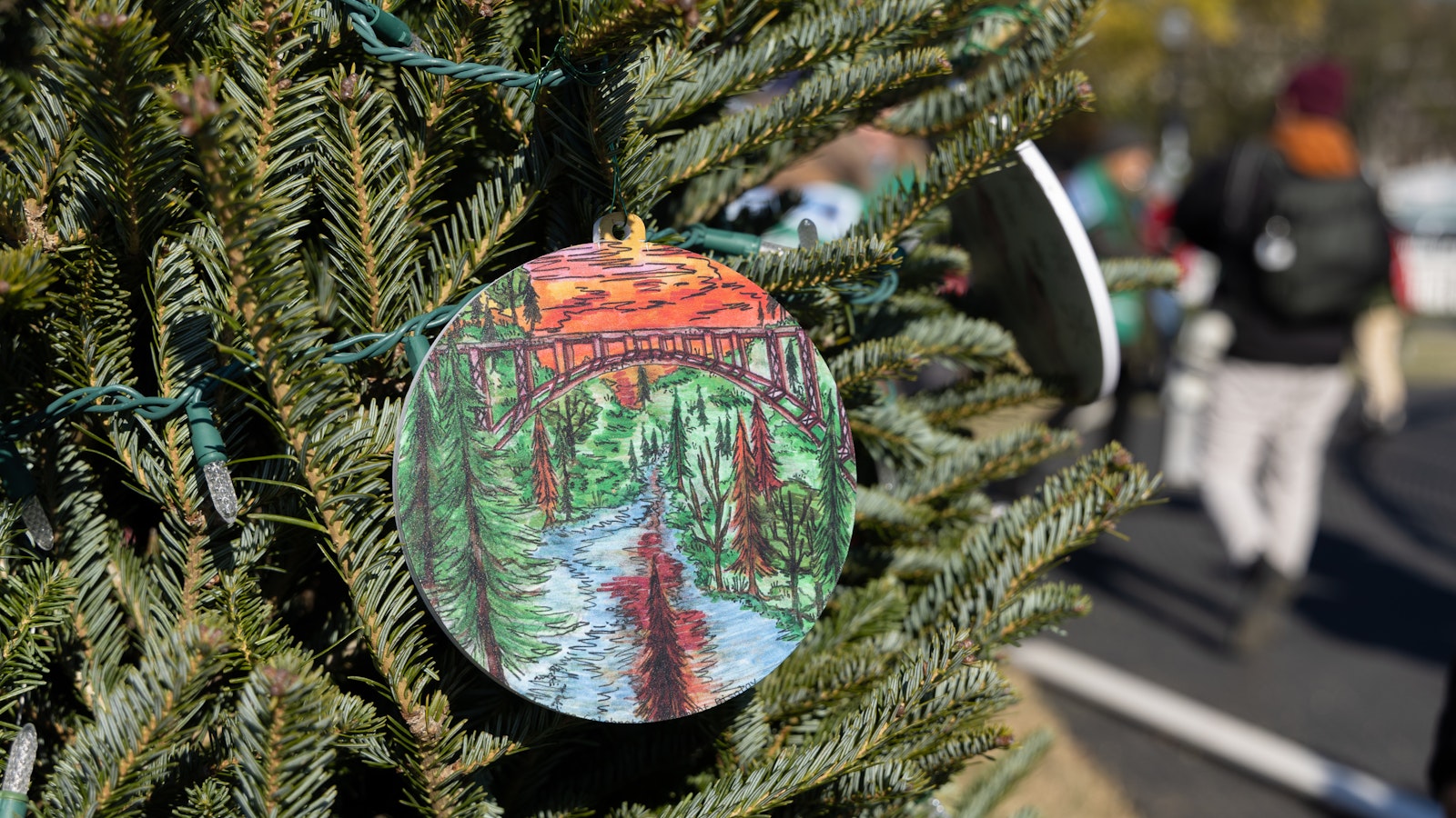 Volunteers decorate the West Virginia state Christmas tree with an ornament of the New River Gorge National Park and Preserve for the 2022 National Christmas Tree Lighting.