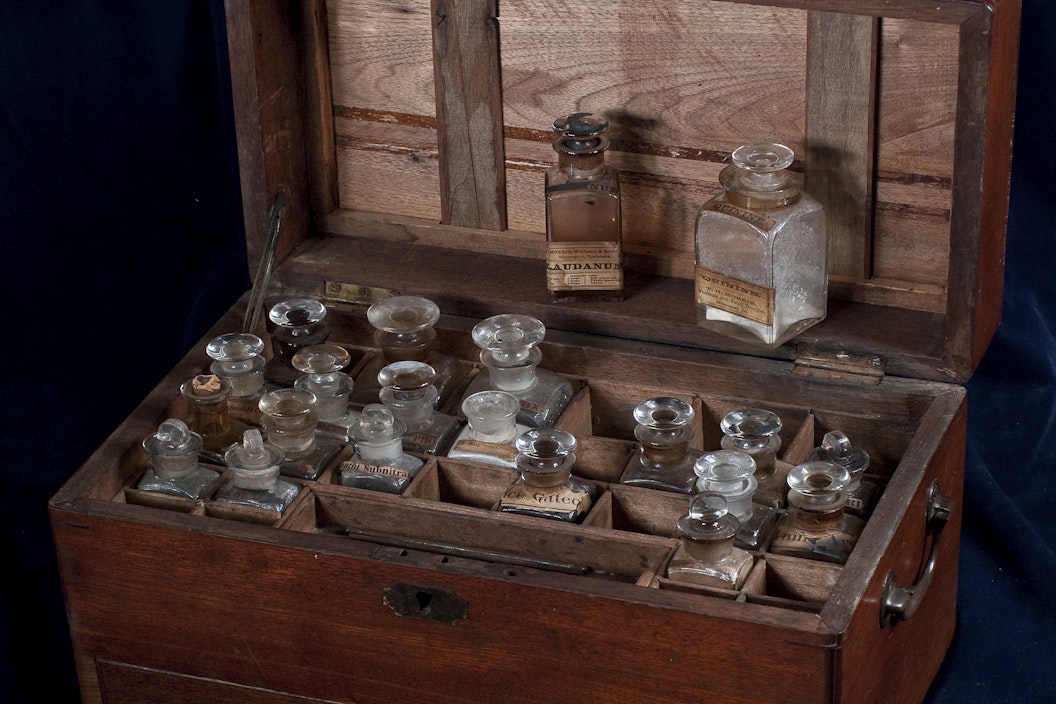 Historical wooden naval apothecary kit with glass vials