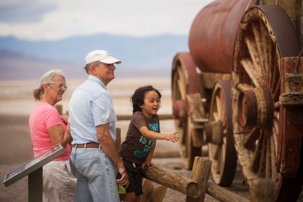Visitors look at a reconstructed covered wagon