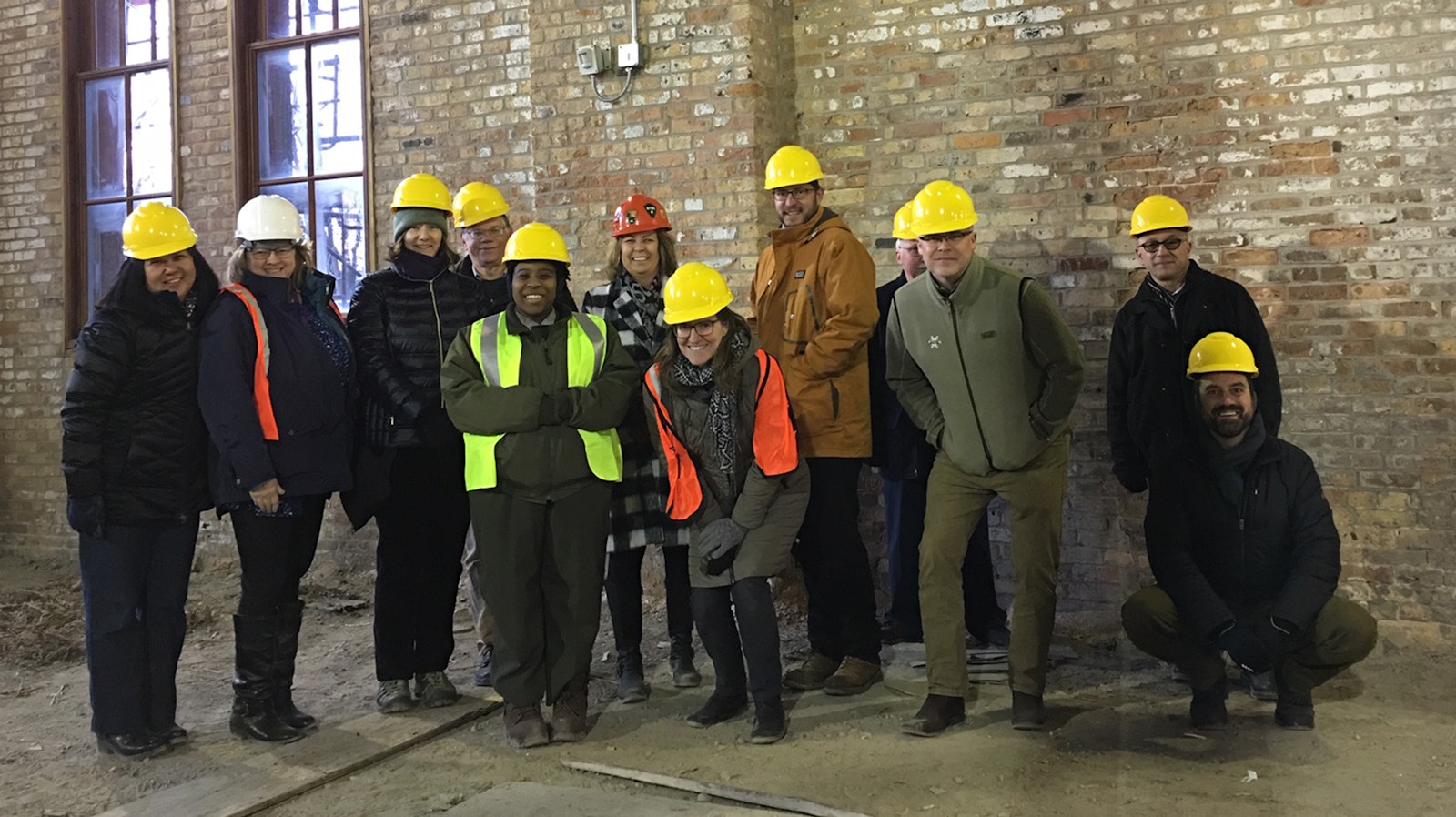 A group of people in hard hats stand together for a picture