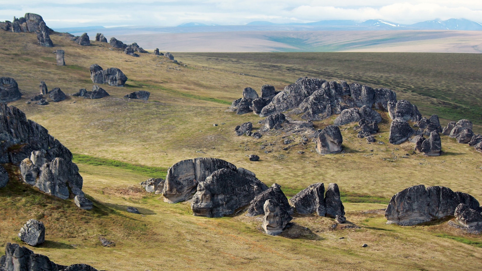 rock formations over a grassy landscape