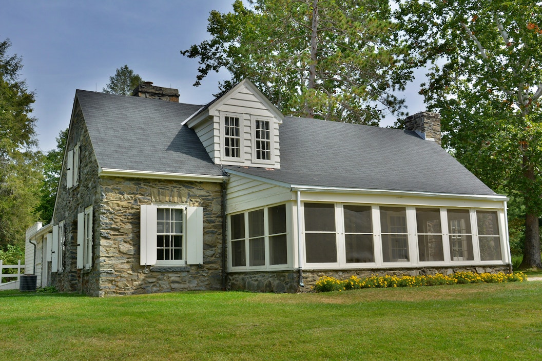 Two story stone cottage with covered porch