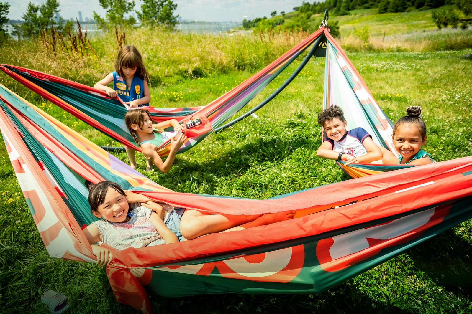Five kids lounge in hammocks