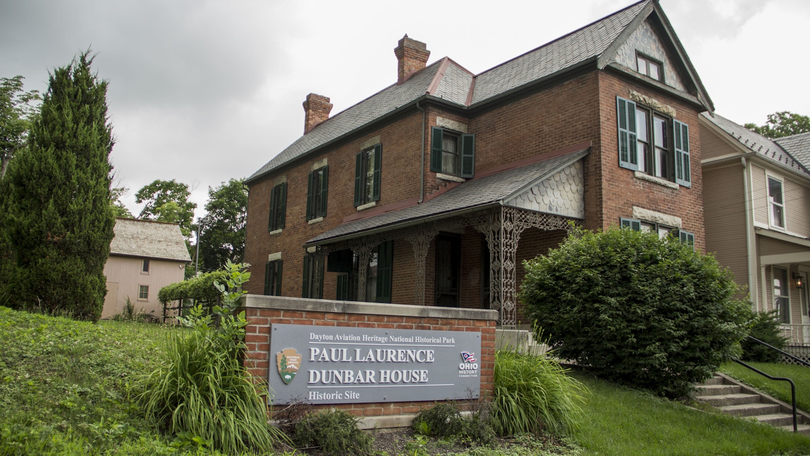 Sign reading "Paul Laurence Dunbar House" outside a two-story brick home