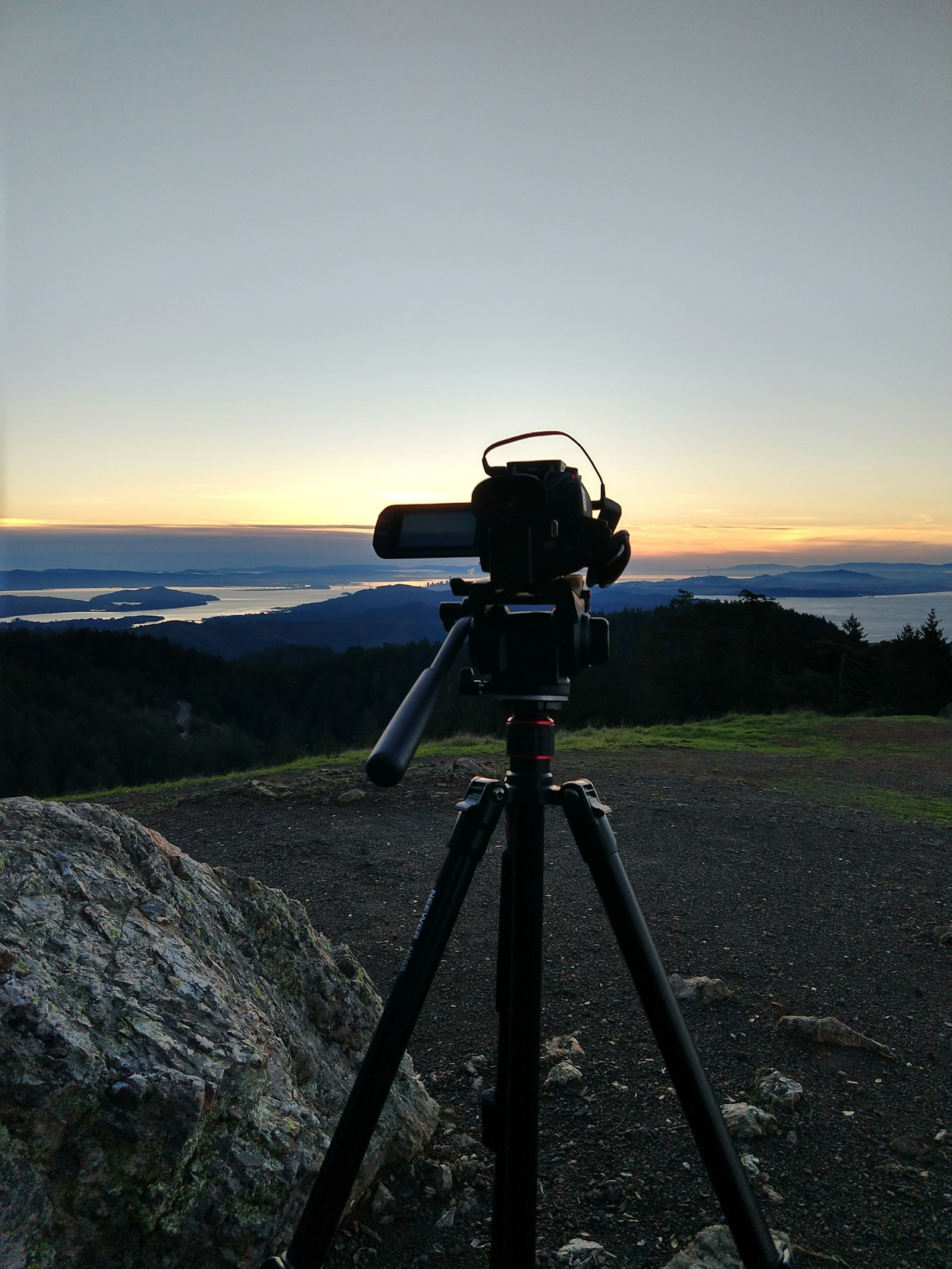 A video camera on a tripod filming the evening sky