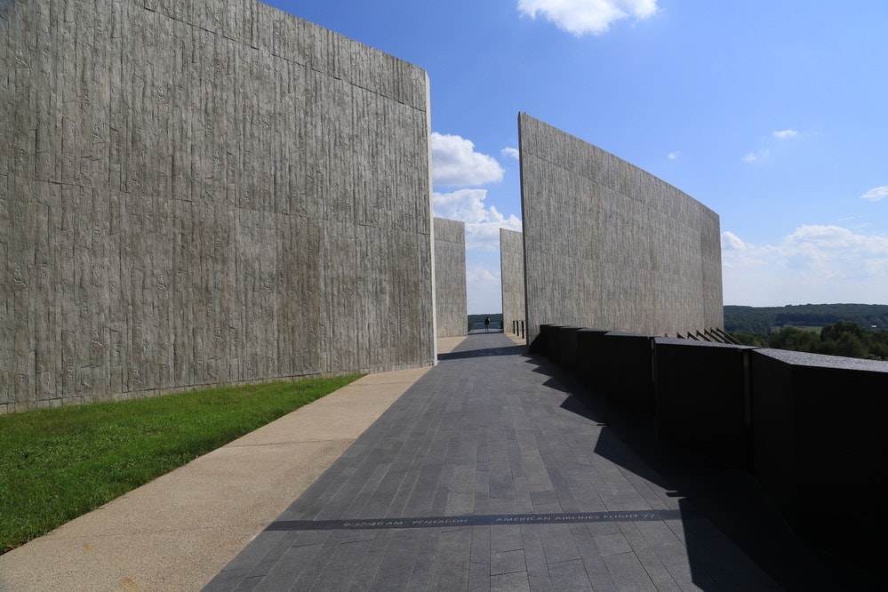 Tall gray concrete walls with gap and black walkway
