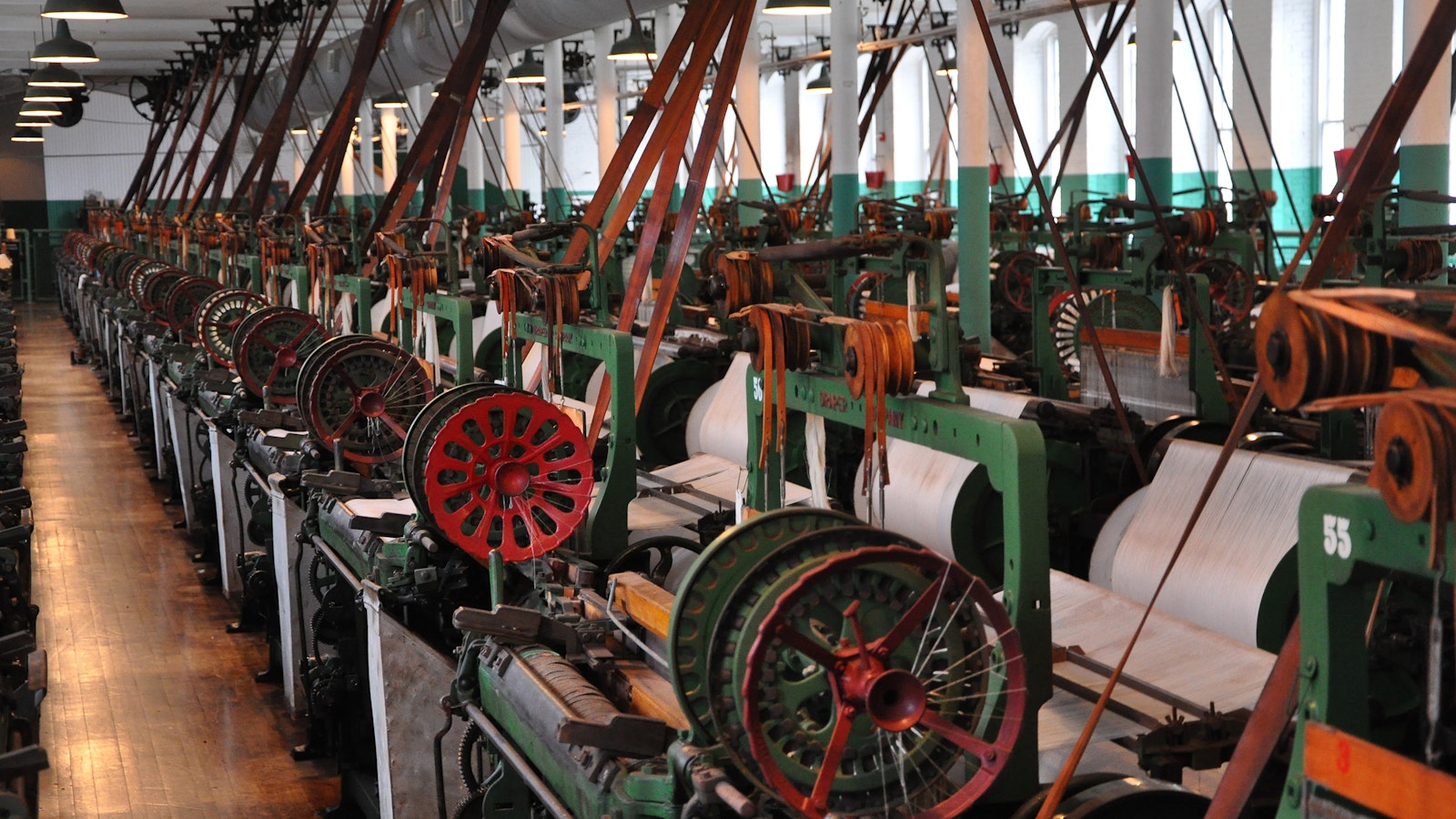 Cotton mill weave room, with green and red mill machines