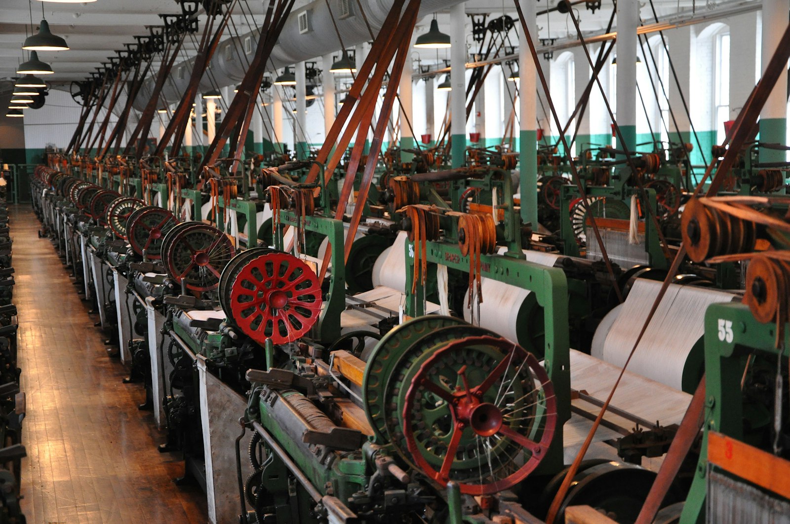 Cotton mill weave room, with green and red mill machines