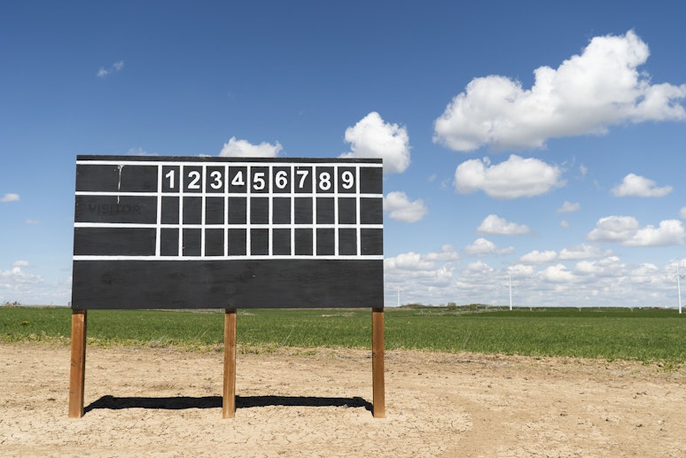 Baseball scoreboard in a large green field